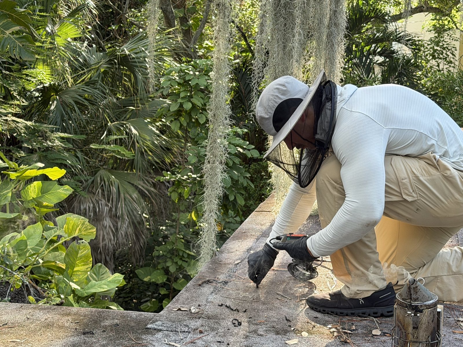 Technician inspecting a Boca Raton roof cavity with an endoscope camera before cutting the roof open